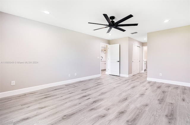 empty room with light wood-type flooring and ceiling fan