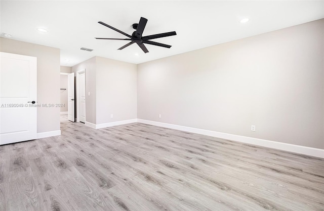 spare room featuring light hardwood / wood-style floors and ceiling fan