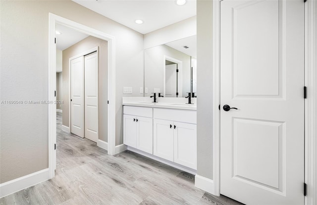 bathroom featuring vanity and hardwood / wood-style floors