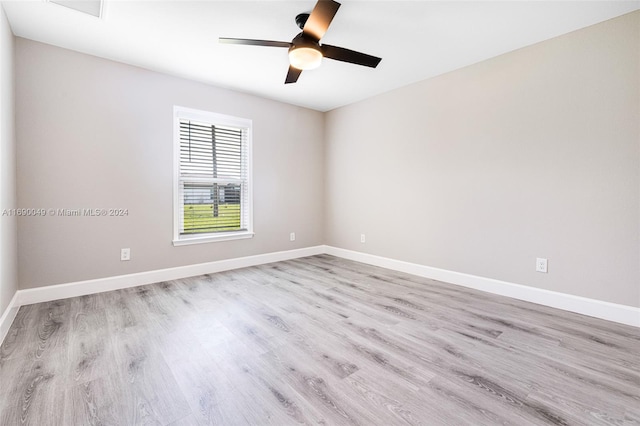 empty room with ceiling fan and light hardwood / wood-style flooring