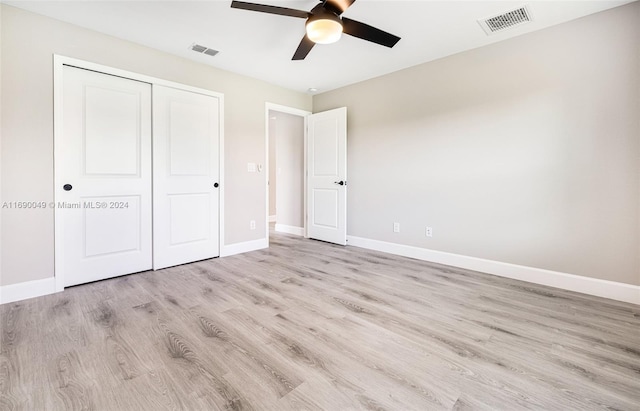 unfurnished bedroom featuring ceiling fan, a closet, and light hardwood / wood-style flooring