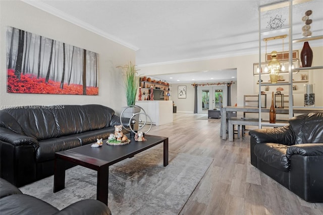 living room featuring light wood-type flooring, french doors, and ornamental molding