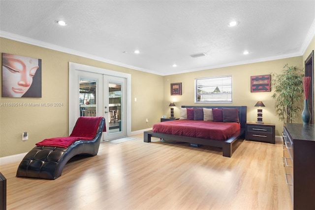 bedroom with access to exterior, multiple windows, light hardwood / wood-style flooring, and french doors