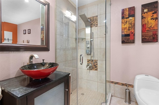 bathroom featuring walk in shower, tile patterned flooring, vanity, and toilet