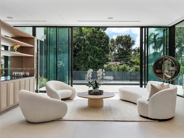 living area featuring floor to ceiling windows and plenty of natural light