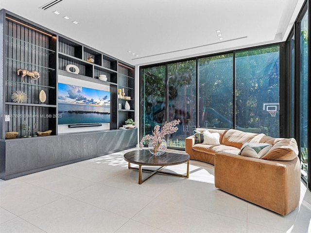 tiled living room featuring floor to ceiling windows and built in shelves