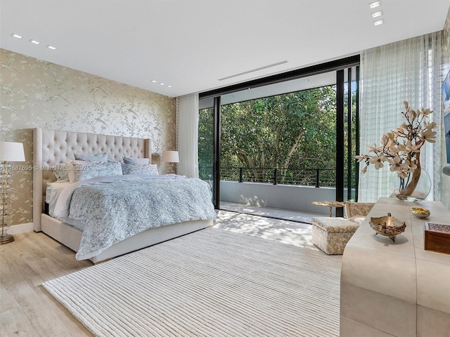 bedroom featuring light hardwood / wood-style floors and expansive windows