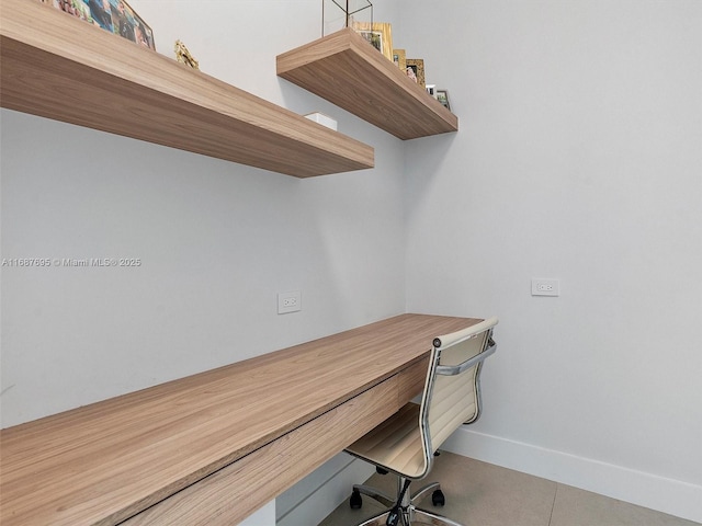 office with tile patterned flooring and built in desk