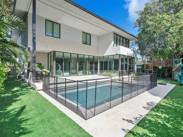 view of pool featuring a yard and a patio