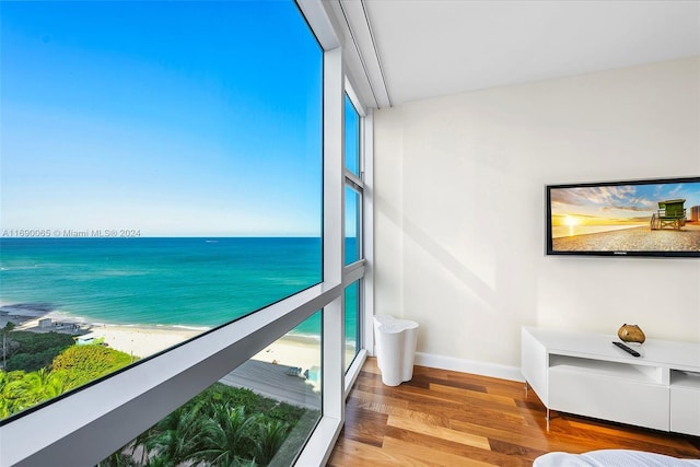 balcony with a water view and a beach view