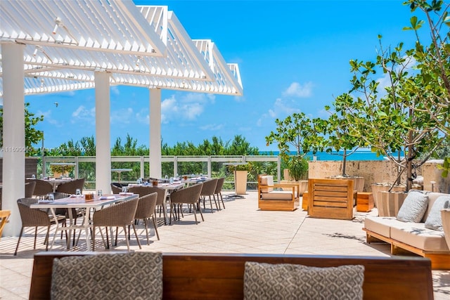 6801 Collins Ave Unit 1215, Miami Beach, FL 33141 - view of patio featuring an outdoor hangout area, a pergola, and outdoor dining space
