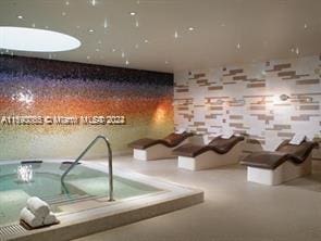 6801 Collins Ave Unit 1215, Miami Beach, FL 33141 - view of swimming pool with a hot tub