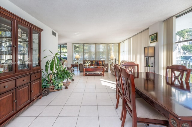 dining room with a healthy amount of sunlight, floor to ceiling windows, and light tile patterned flooring