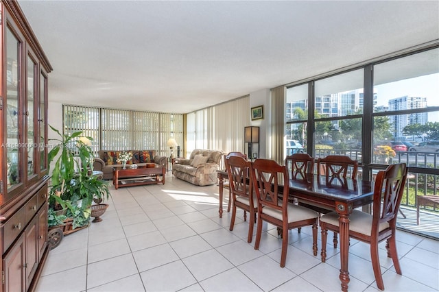 dining room with a view of city, a healthy amount of sunlight, and floor to ceiling windows