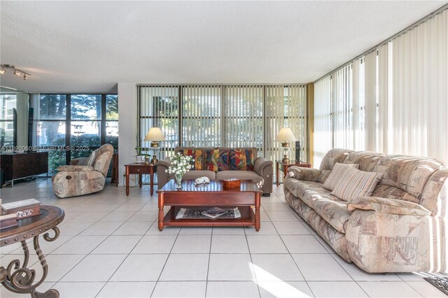 living room with floor to ceiling windows, light tile patterned floors, and plenty of natural light