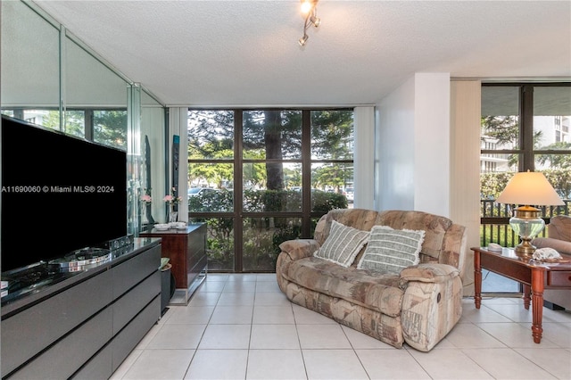 living room with a wall of windows, a healthy amount of sunlight, and a textured ceiling