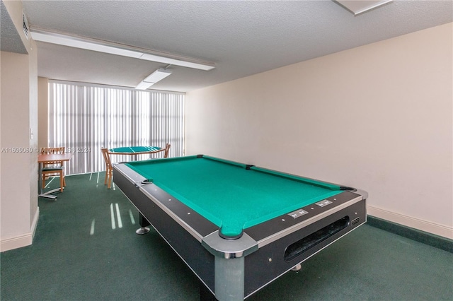 game room with dark colored carpet, billiards, and a textured ceiling