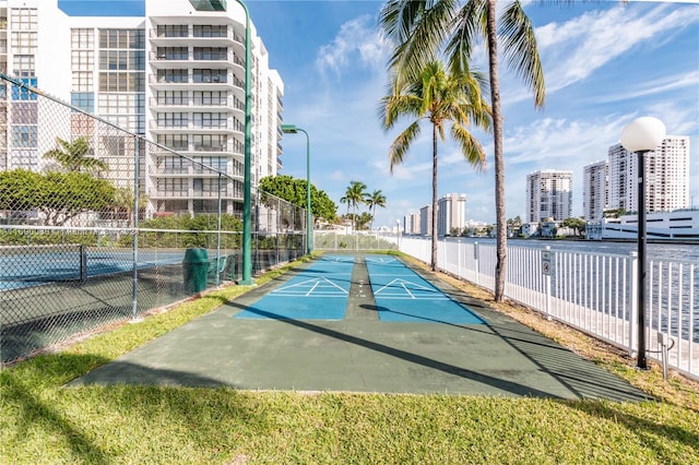 view of property's community featuring tennis court