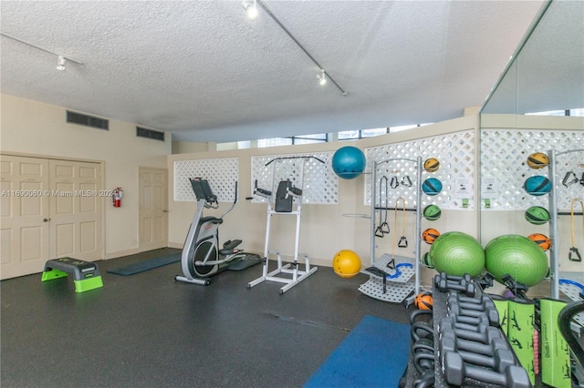 gym featuring a textured ceiling