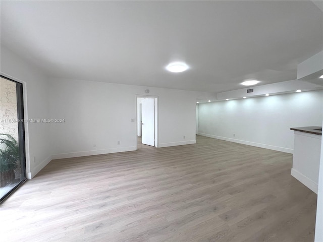 empty room with light hardwood / wood-style flooring