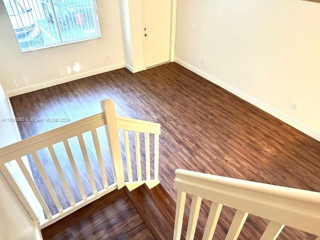 staircase with hardwood / wood-style floors