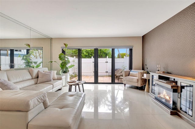 21300 San Simeon Way Unit K2, Miami, FL 33179 - living room with french doors, light tile patterned floors, a glass covered fireplace, and an accent wall