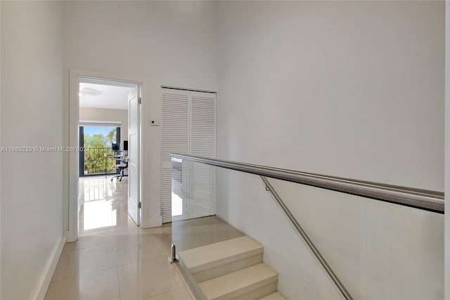 stairway with tile patterned flooring