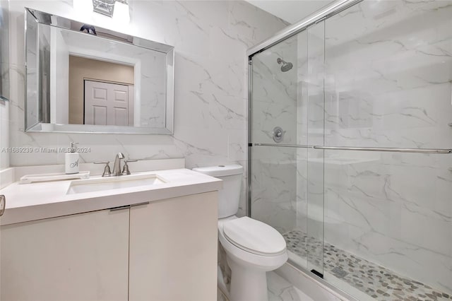 21300 San Simeon Way Unit K2, Miami, FL 33179 - full bathroom with marble look tile flooring, a shower stall, toilet, vanity, and tile walls