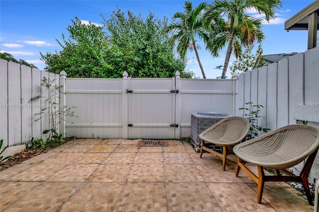 21300 San Simeon Way Unit K2, Miami, FL 33179 - view of patio with a gate, cooling unit, and a fenced backyard