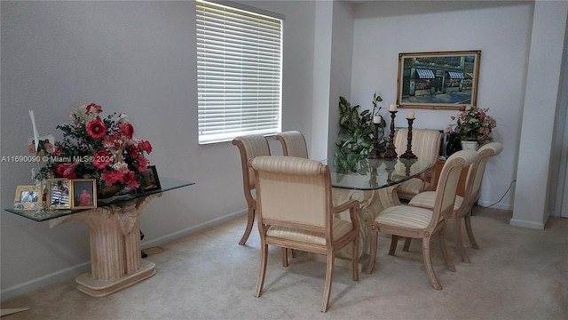 dining area featuring plenty of natural light and light colored carpet