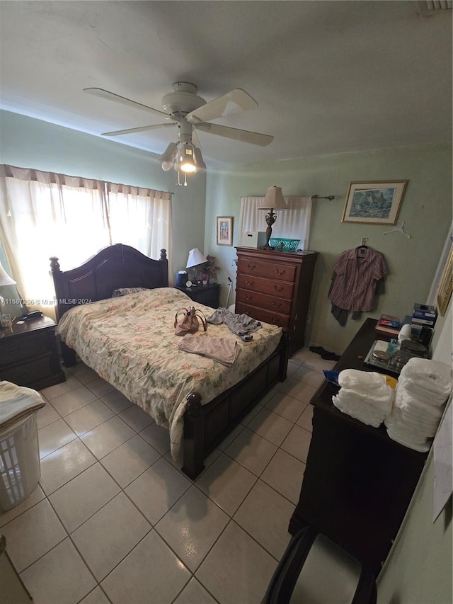 tiled bedroom with ceiling fan