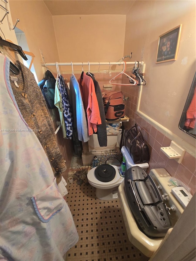 bathroom with tile walls