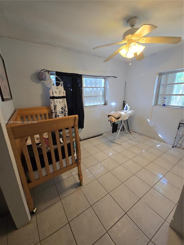 tiled dining space featuring ceiling fan and plenty of natural light