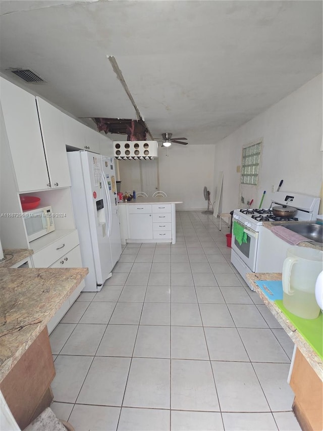 kitchen with kitchen peninsula, light tile patterned flooring, ceiling fan, white cabinetry, and white appliances