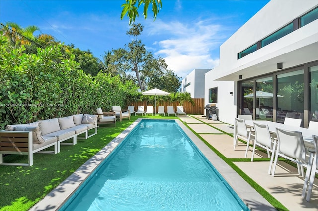 view of pool with outdoor lounge area and a patio