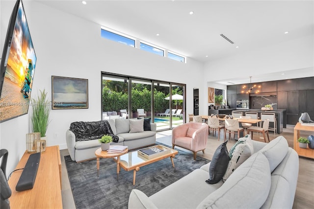 living room featuring hardwood / wood-style floors and a towering ceiling