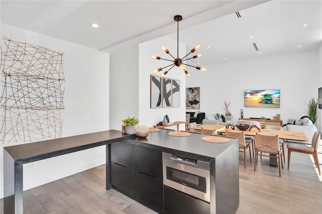 kitchen featuring light hardwood / wood-style flooring and a notable chandelier