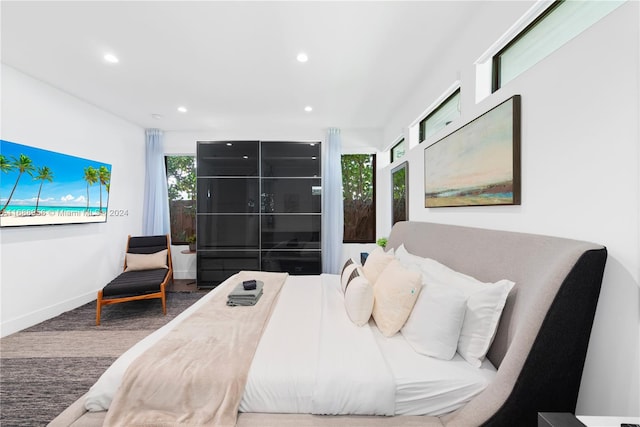 bedroom with multiple windows and carpet floors