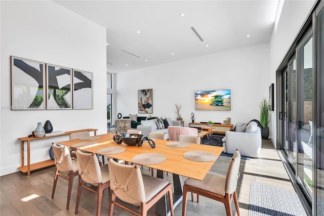 dining space with wood-type flooring