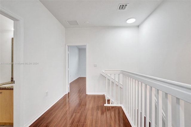 hall with hardwood / wood-style flooring