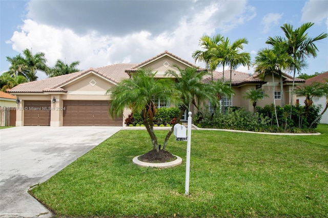 mediterranean / spanish home with a garage and a front yard