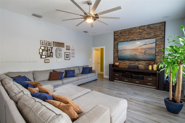 living room featuring ceiling fan and light hardwood / wood-style flooring