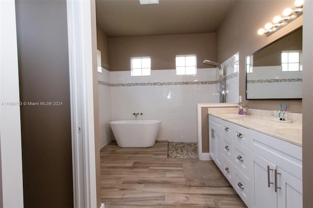 bathroom featuring hardwood / wood-style floors, a wealth of natural light, vanity, and shower with separate bathtub