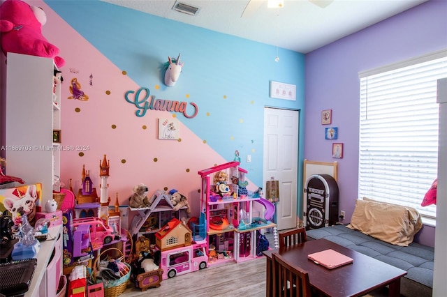 game room featuring light hardwood / wood-style flooring and ceiling fan