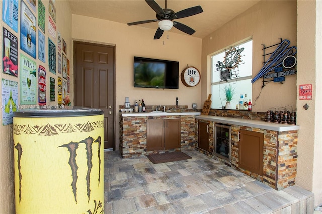 view of patio / terrace with area for grilling, ceiling fan, and wine cooler