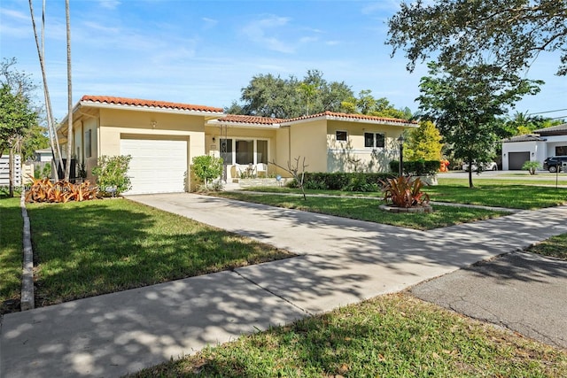 mediterranean / spanish-style home with a front lawn and a garage