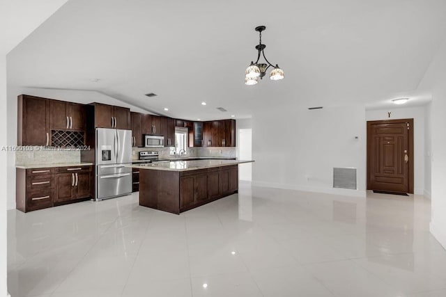 kitchen featuring pendant lighting, an inviting chandelier, vaulted ceiling, dark brown cabinets, and stainless steel appliances