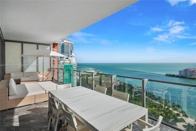 balcony featuring a water view and outdoor lounge area