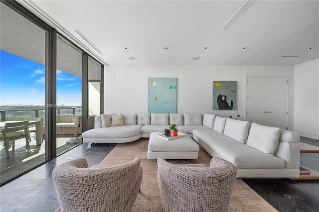 living room featuring a wall of windows and concrete floors