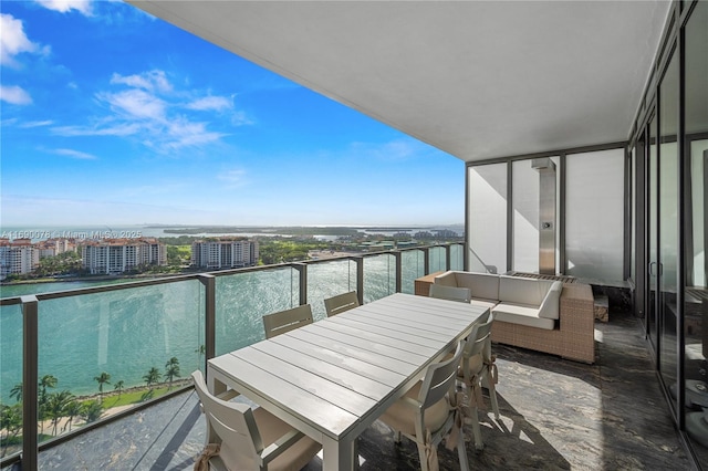 balcony featuring a water view and an outdoor hangout area